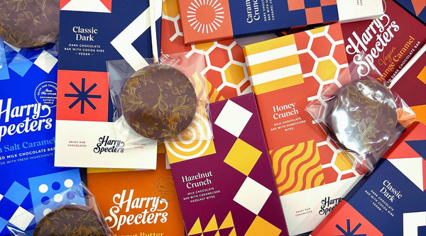 A selection of chocolate bars and lollipops in colourful packaging