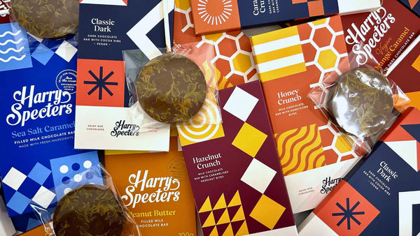 A selection of luxury chocolate bars and lollipops with colourful Harry Specters packaging