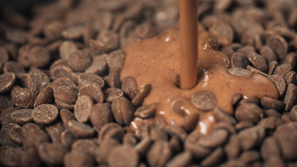 Milk chocolate melting onto a bed of chocolate callets