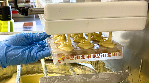 Melted white chocolate being poured into a mould