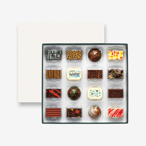 A box of 16 artisan chocolates colourfully decorated and featuring two Happy Holidays themed designs