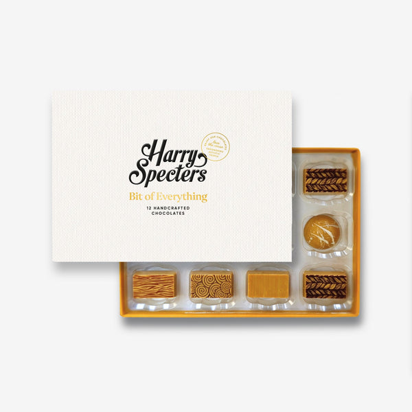 A box of 12 artisan blonde chocolates by Harry Specters partially covered by a box lid 