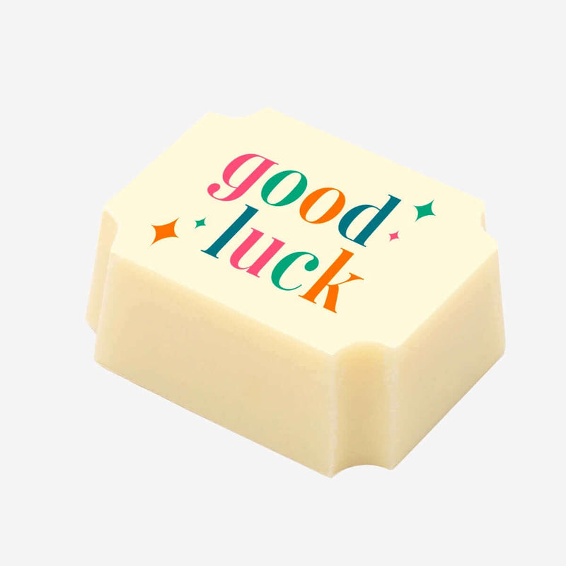 A white chocolate with a good luck message printed on the top