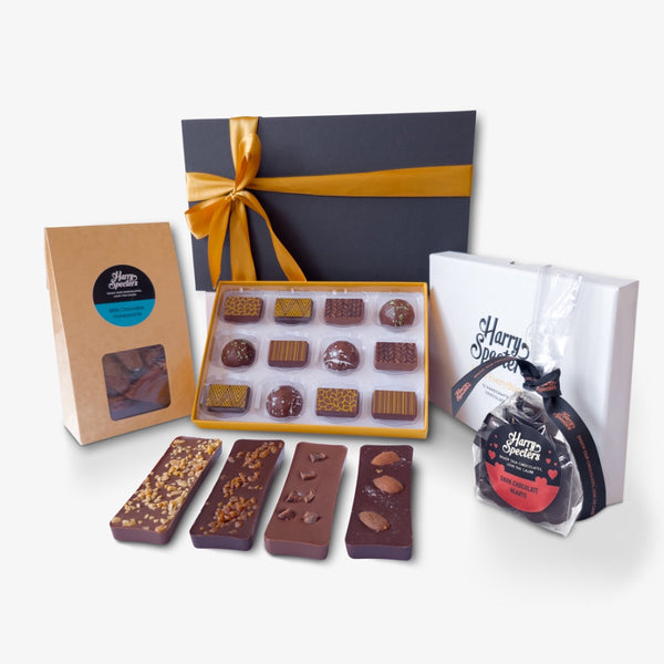 A small Valentine's chocolate hamper including mini chocolate bars, coffee beans, heart shapes, and a box of luxury chocolates